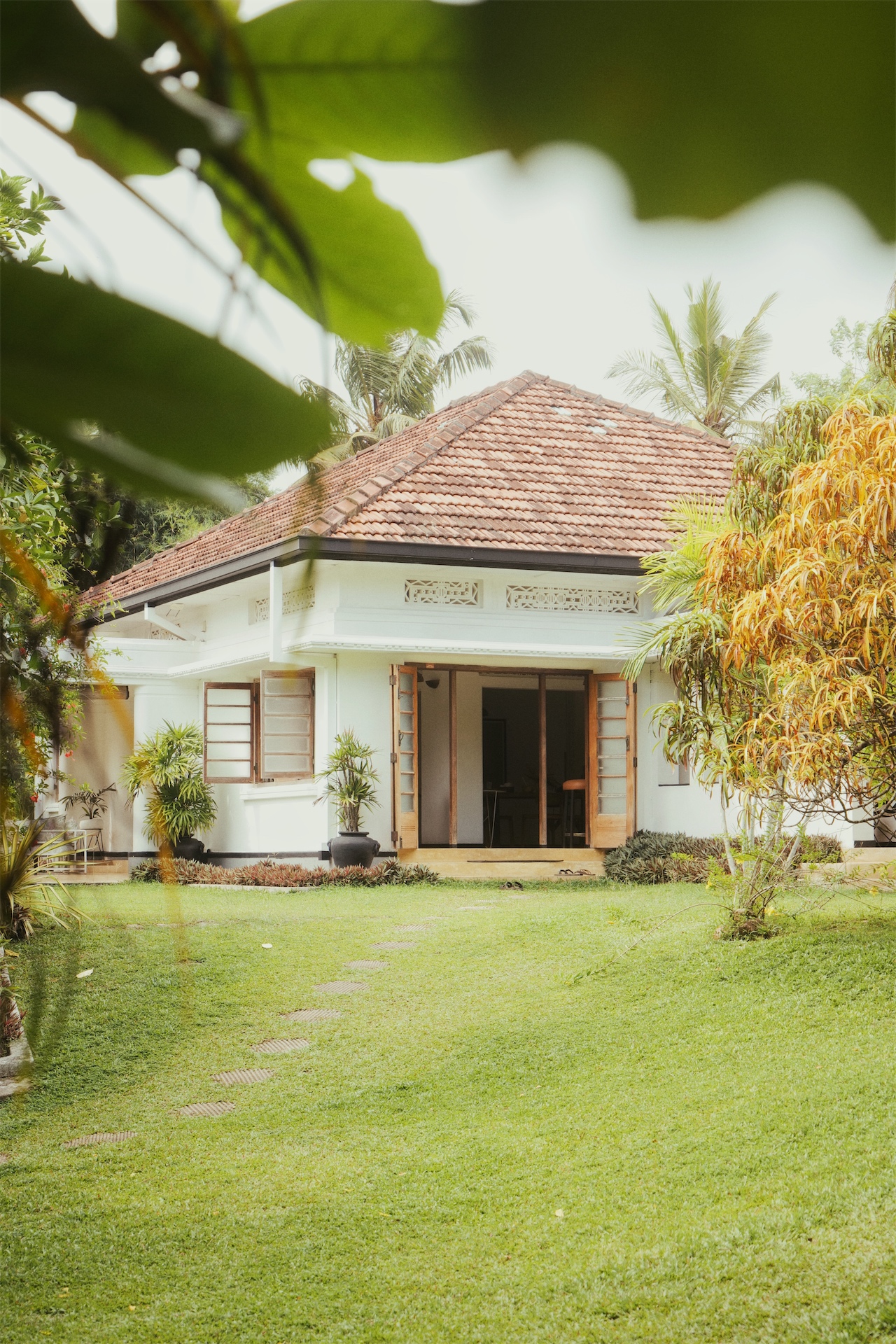 Exterior view of Abode Ahangama surrounded by tropical gardens in Sri Lanka.