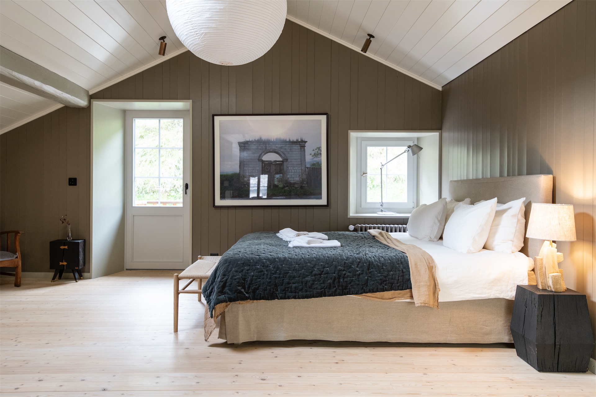 Bedroom with wood-panelled walls and soft lighting at Brücke 49.