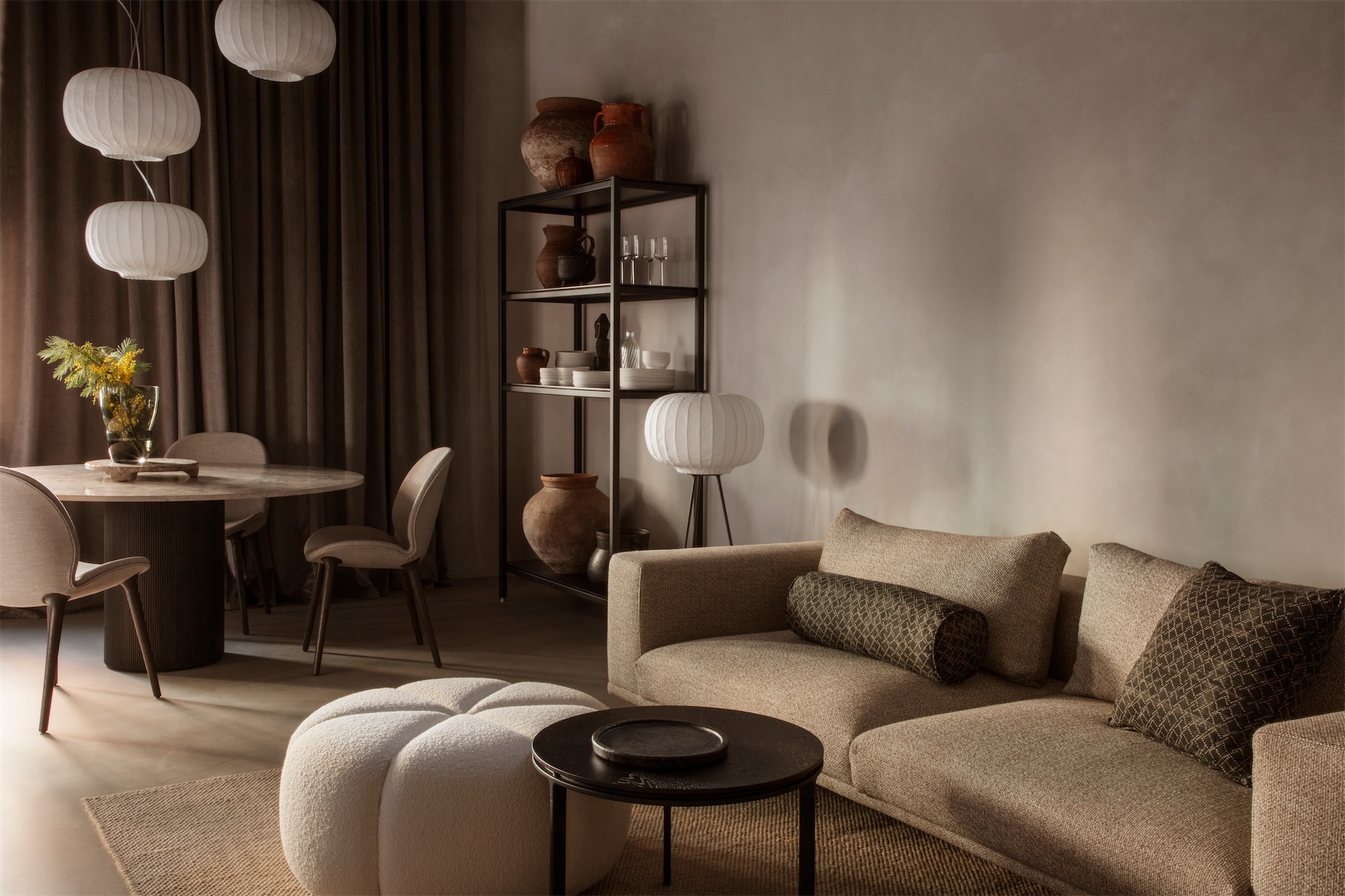 Neutral sofa and round dining table in open-plan living space at Casa Vipp.