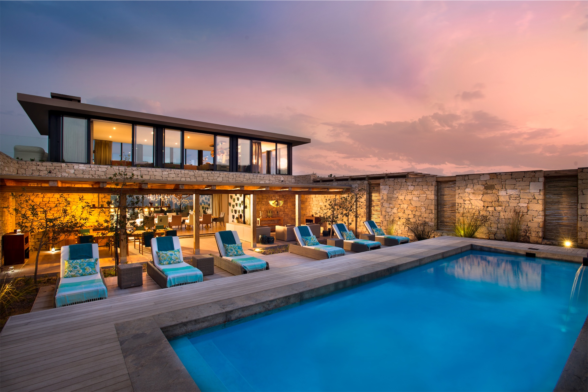 Swimming pool and terrace at dusk at Morukuru Ocean House.