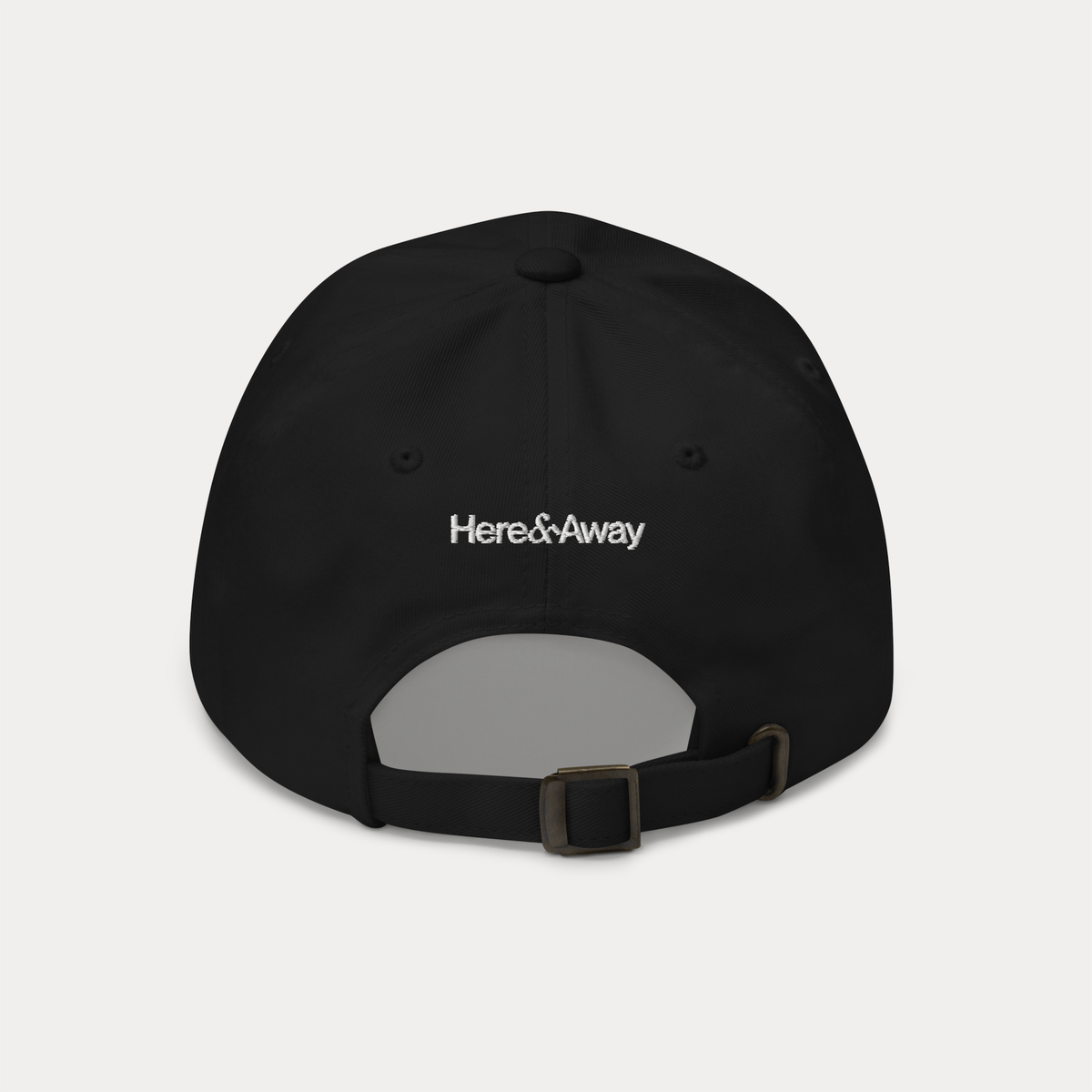 Black dad hat back view with adjustable strap and Here & Away design