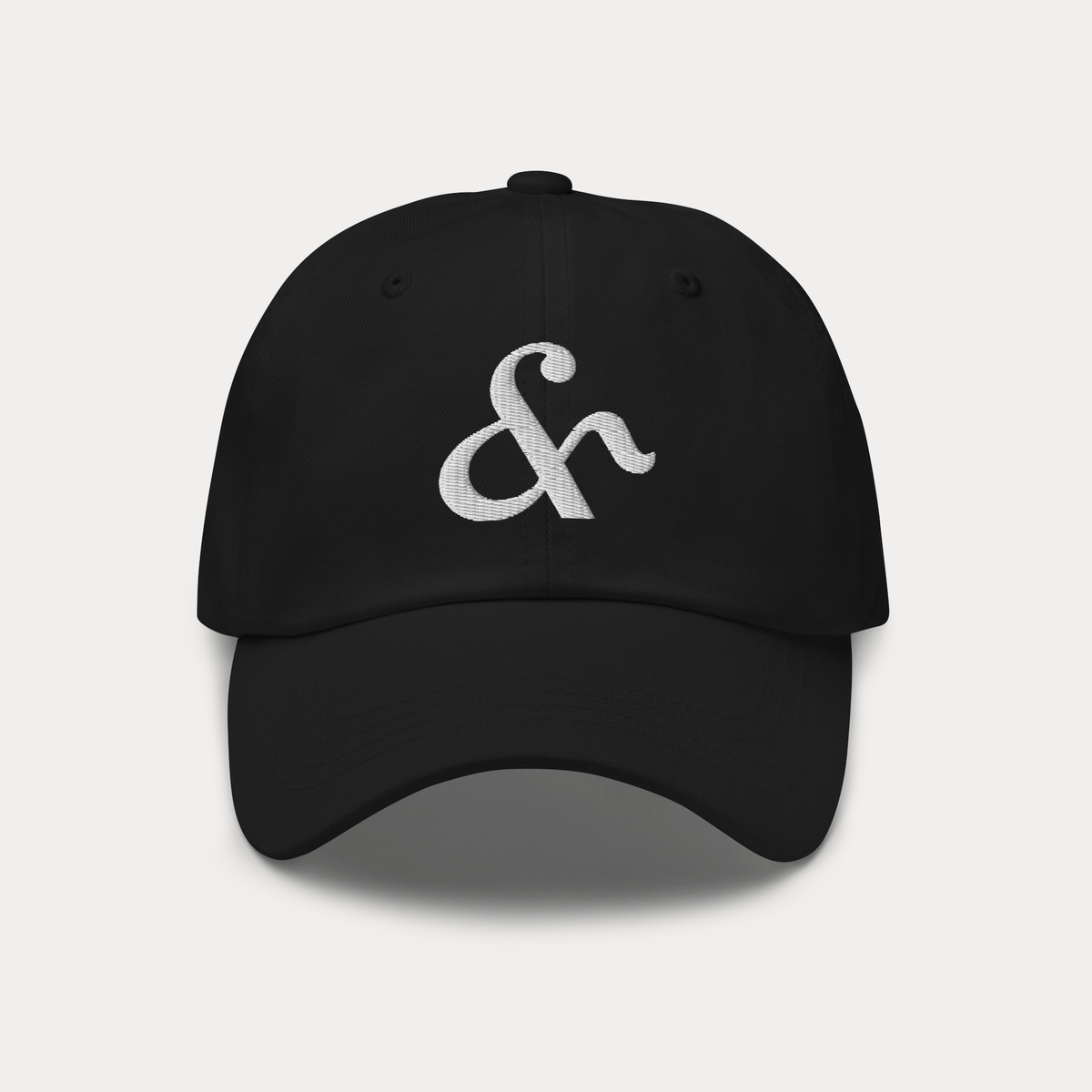 Black dad hat with Here & Away embroidered logo in cotton twill