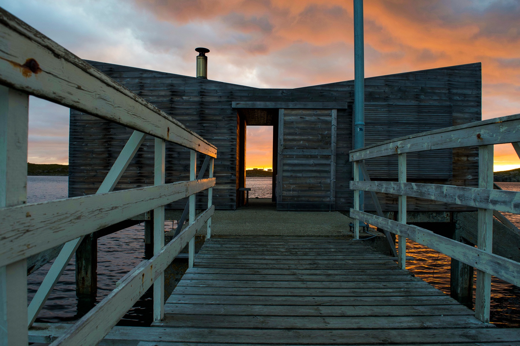 arctic hideaway waterfront cabin sunset