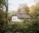 White farmhouse cottage with traditional thatched roof at Vipp Farmhouse.