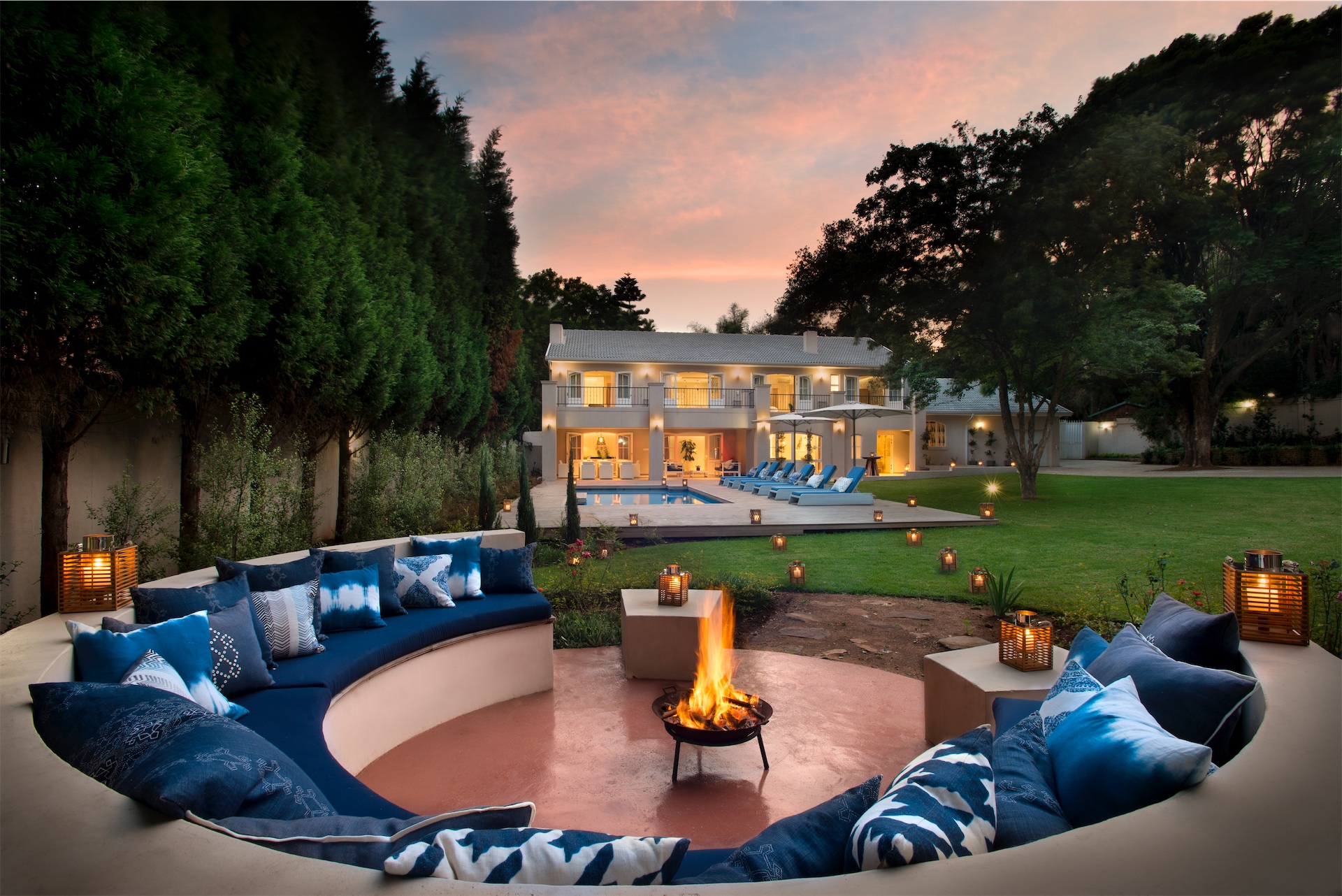 Twilight exterior view of private villa at AtholPlace Hotel & Villa with illuminated pool and gardens.