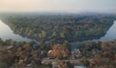 An aerial view of dense forest surrounded by a winding river at Lolelunga Private Reserve.