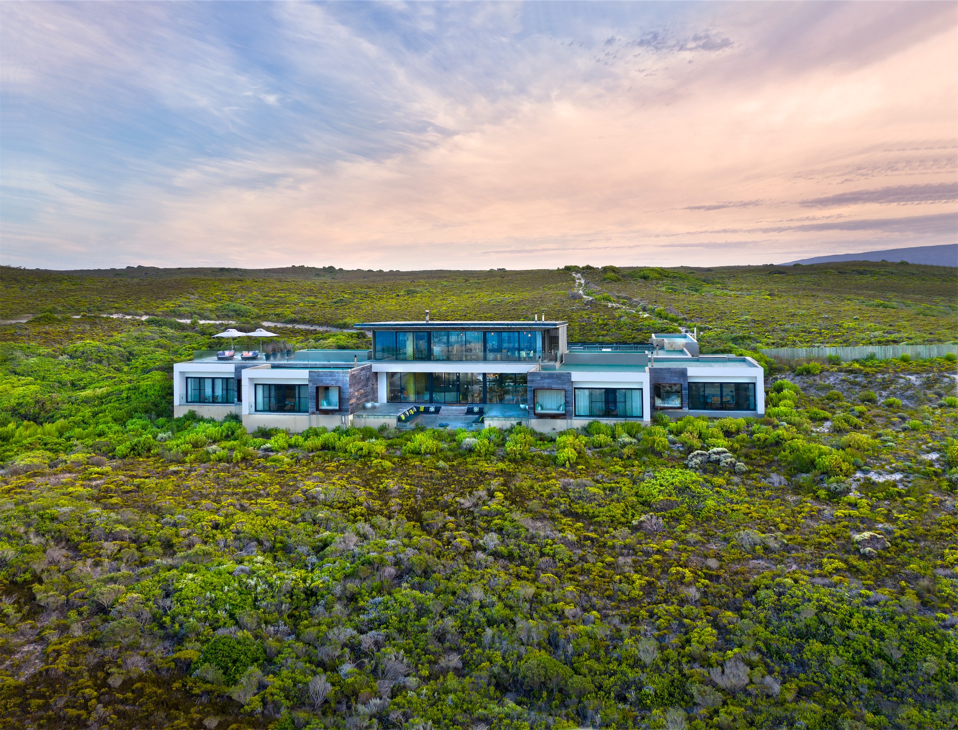 Aerial view of Morukuru Beach Lodge set within coastal fynbos near the ocean.