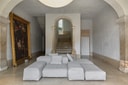 Low modular linen sofa set within a vaulted historic interior at Santa Clara 1728.