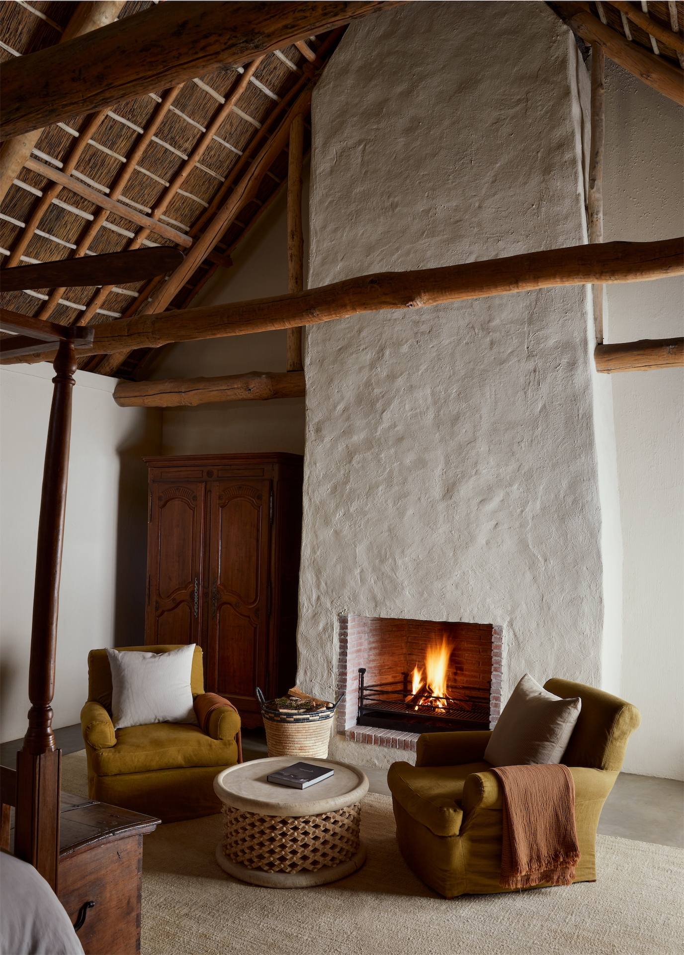 Farm suite with thatched ceiling, exposed timber beams and plaster fireplace at Sterrekopje Farm.