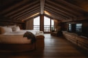 Luxury alpine bedroom with balcony and mountain views at Zannier Le Chalet.