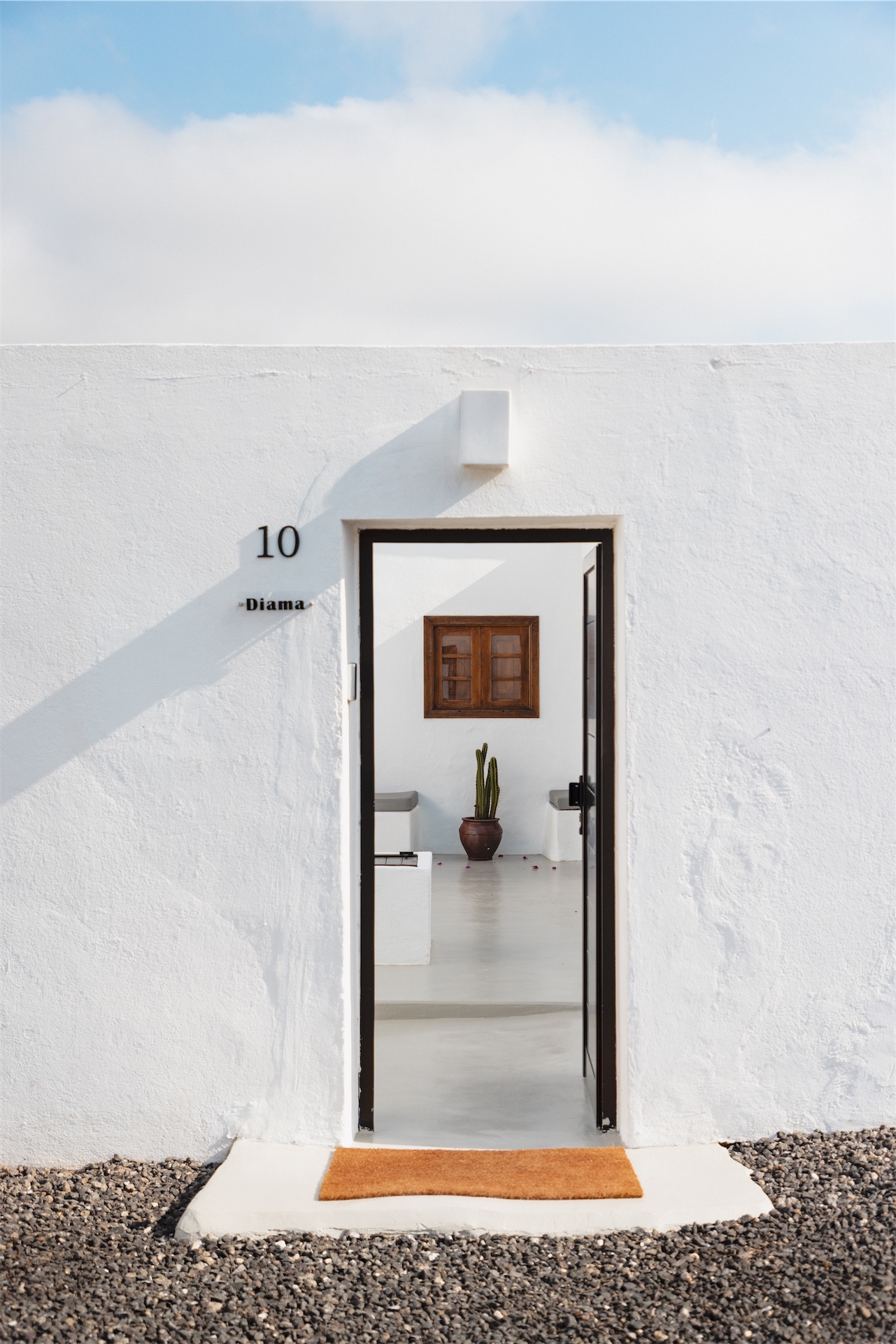 Exterior entrance with open doorway revealing interior at La Casita de Femés.
